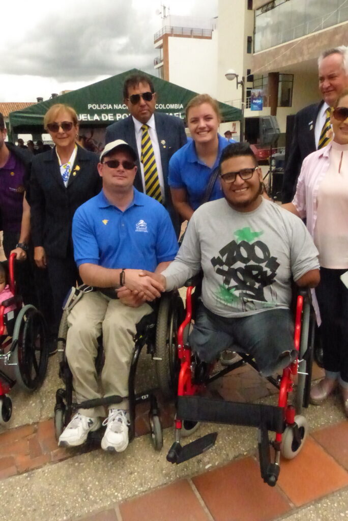 Josh proudly smiles with a wheelchair recipient in Paipa, Colombia in 2018. Severely injured in a workplace explosion, the young man is now able to live a much more enhanced mobile life.