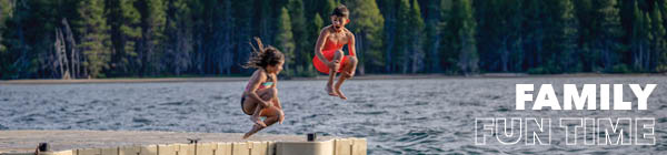 Kids jumping off a dock into a lake