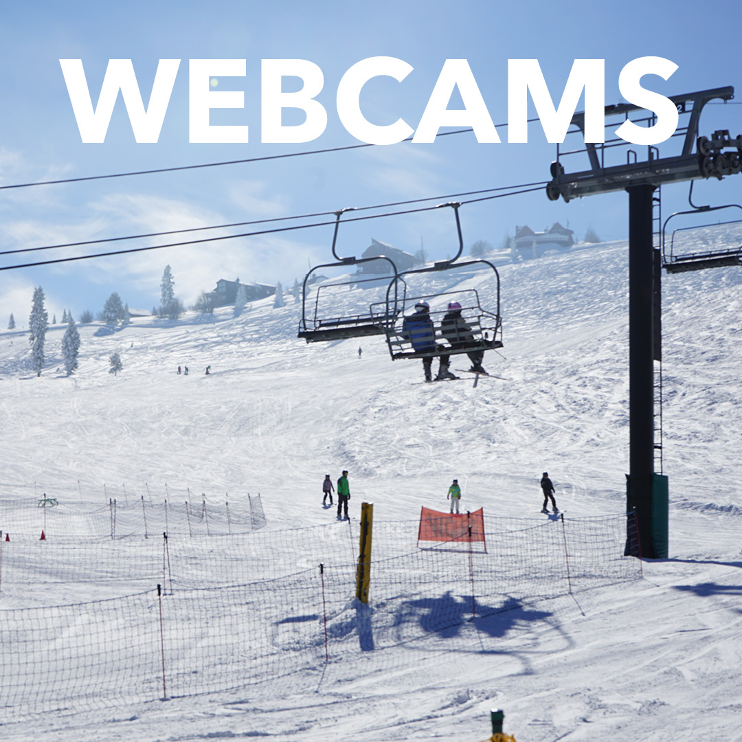 Far away shot of a chair lift with text overlay saying Webcams