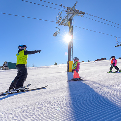 Ski instructor giving kids a lesson